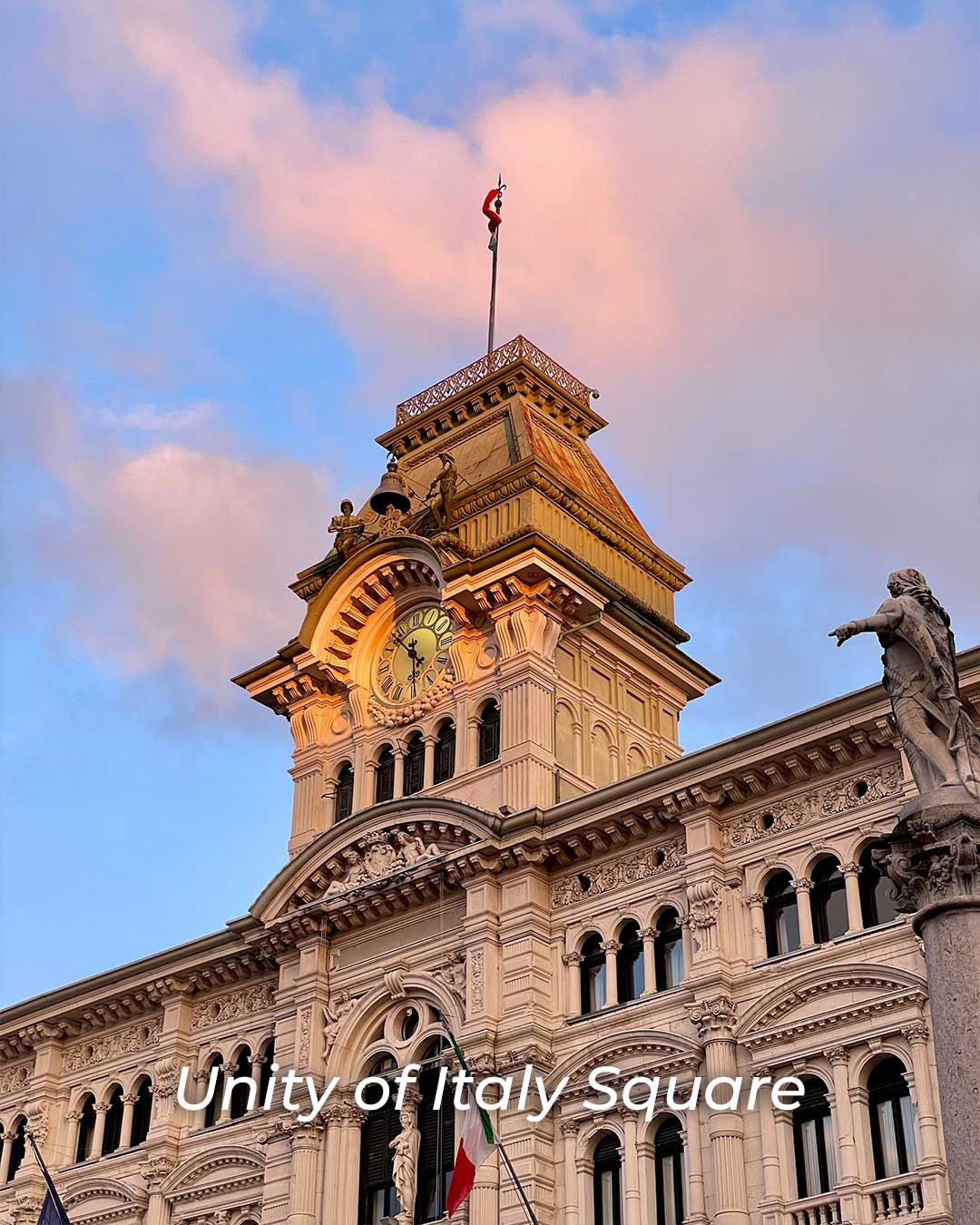 Clock tower building at Piazza Unità d’Italia in Trieste, photographed during golden hour with warm sunlight